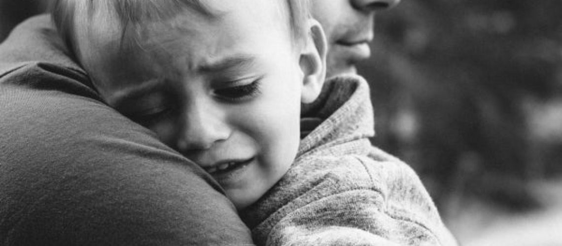 Dad Hugs Crying Son